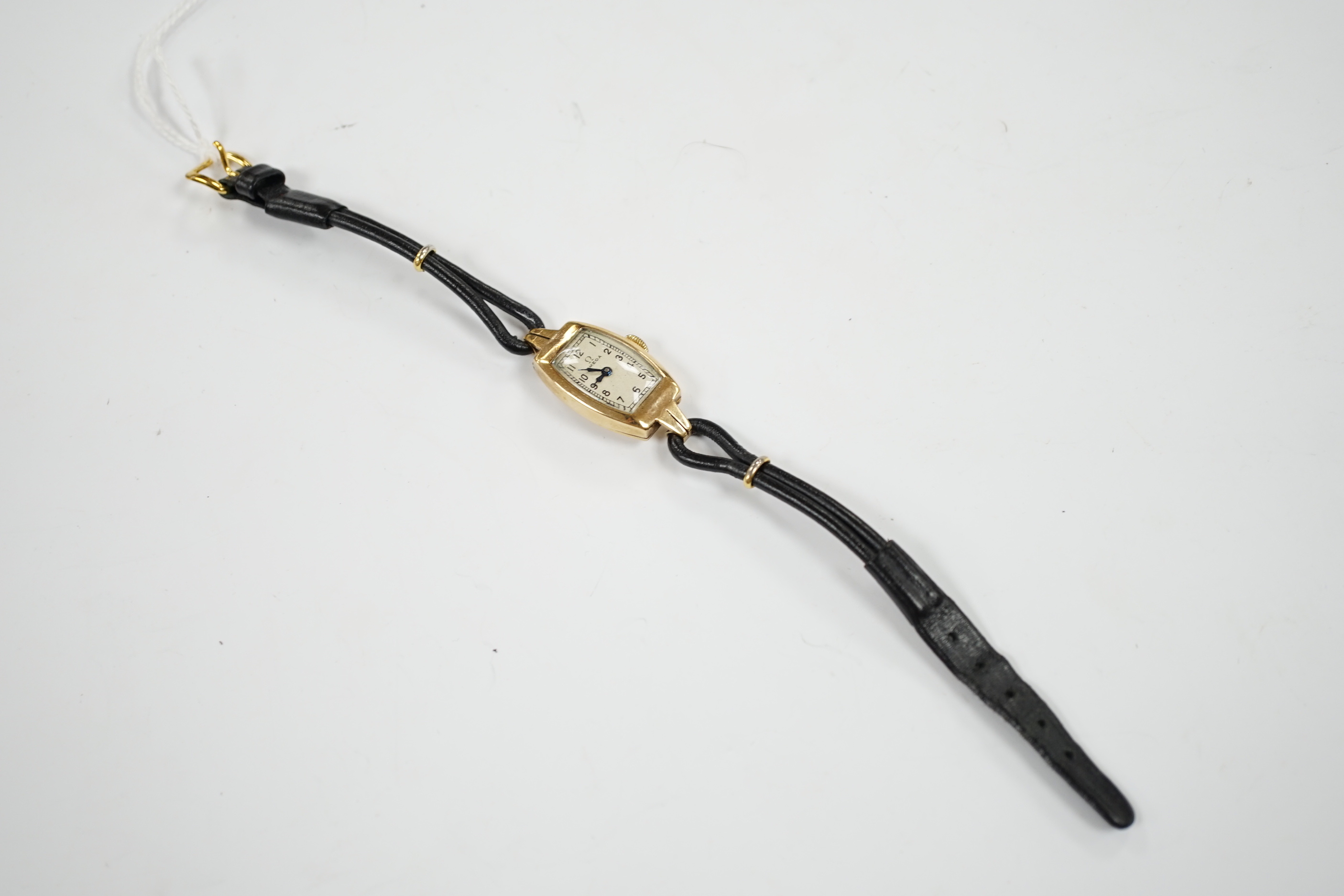 A lady’s 9ct gold Omega manual wind wrist watch, on a twin fabric strap.